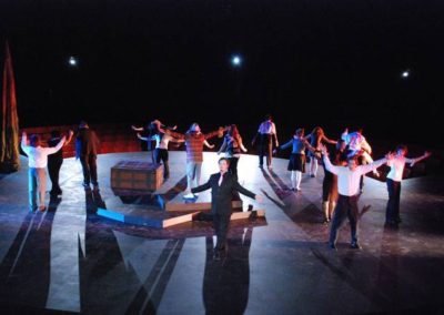 curtain call/bows, eighteen people across the stage in various poses