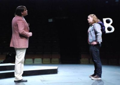 a man talking to a woman, the woman has a giant turnkey sticking out of her back