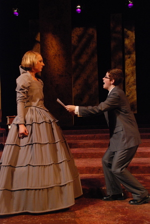 a man presents a written letter to a woman in an excited fashion