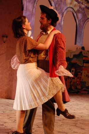 a man and a woman dancing, the man is holding the woman's right leg with his left hand