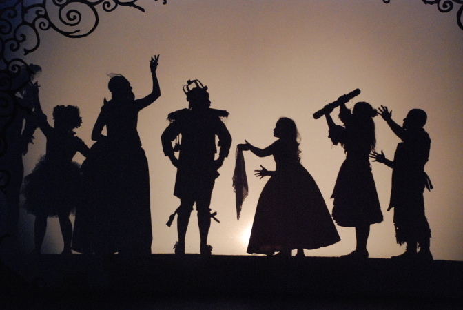 silhouette of the royal family, seven people in a variety of costumes and poses
