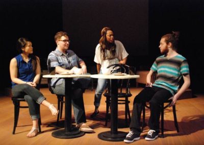 four people sitting and talking at cafe tables