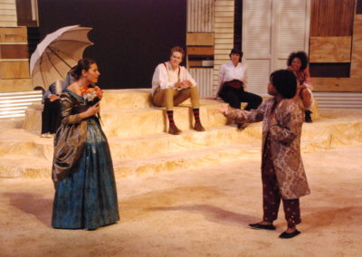 four people watching a man and a woman talking, the woman is holding a parasol