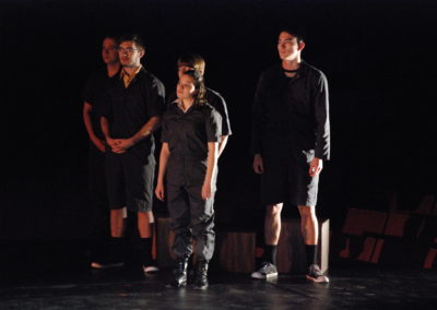 five people standing and looking to their right, strong side light