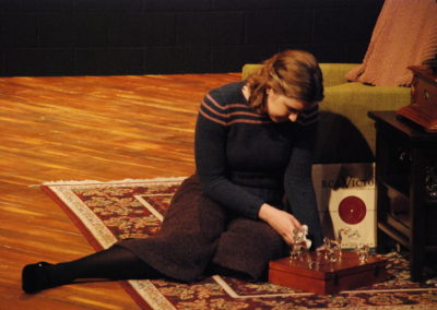 woman sitting on the ground playing with her glass menagerie